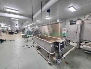 Stainless steel industrial tray washer with lid open showing washing chamber interior