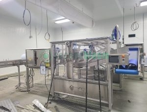 Viscon harvesting system with touchscreen control panel, safety enclosures, and conveyor integration in food processing facility