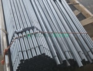 Close-up of galvanized steel bench components showing white PVC connector pieces integrated with metal frame parts