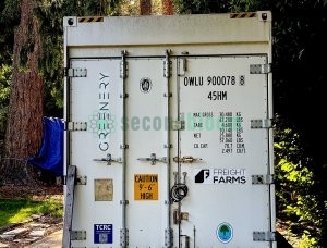 White Freight Farms shipping container with rear doors and company logo in outdoor setting